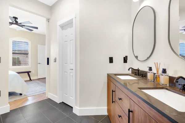a bathroom with a double vanity sink and a mirror