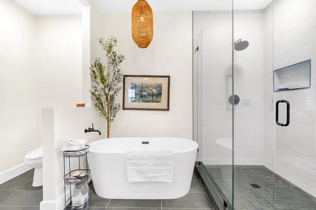 a bathroom with a tub and shower