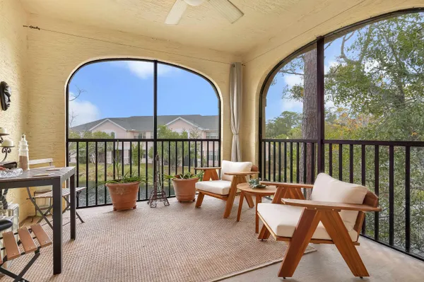 a balcony with a table and chairs