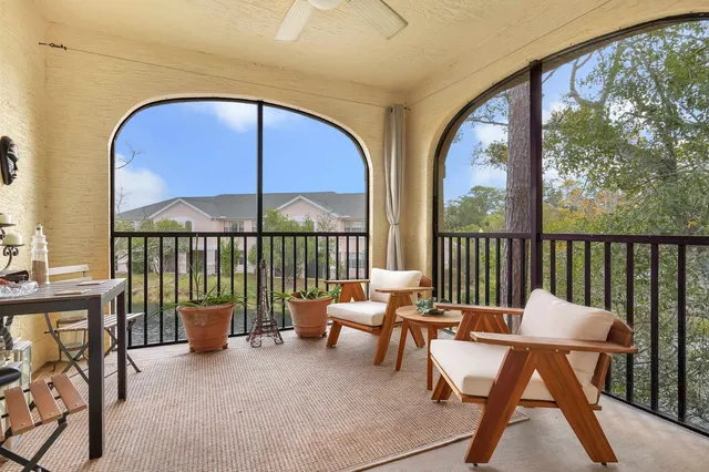a balcony with a table and chairs