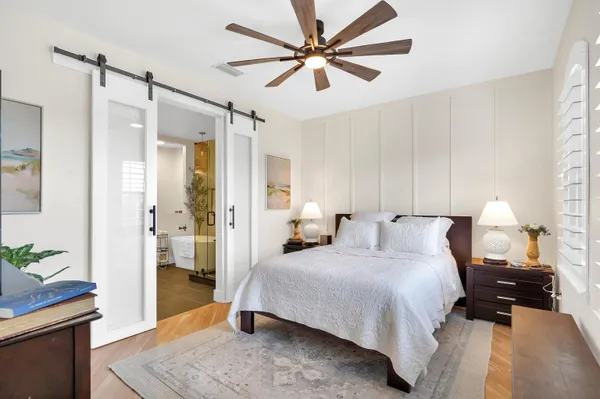 a bedroom with a bed and a chandelier