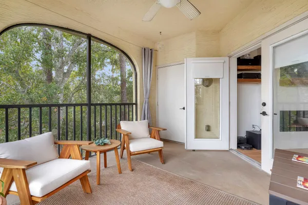 a living room with furniture and a floor to ceiling window