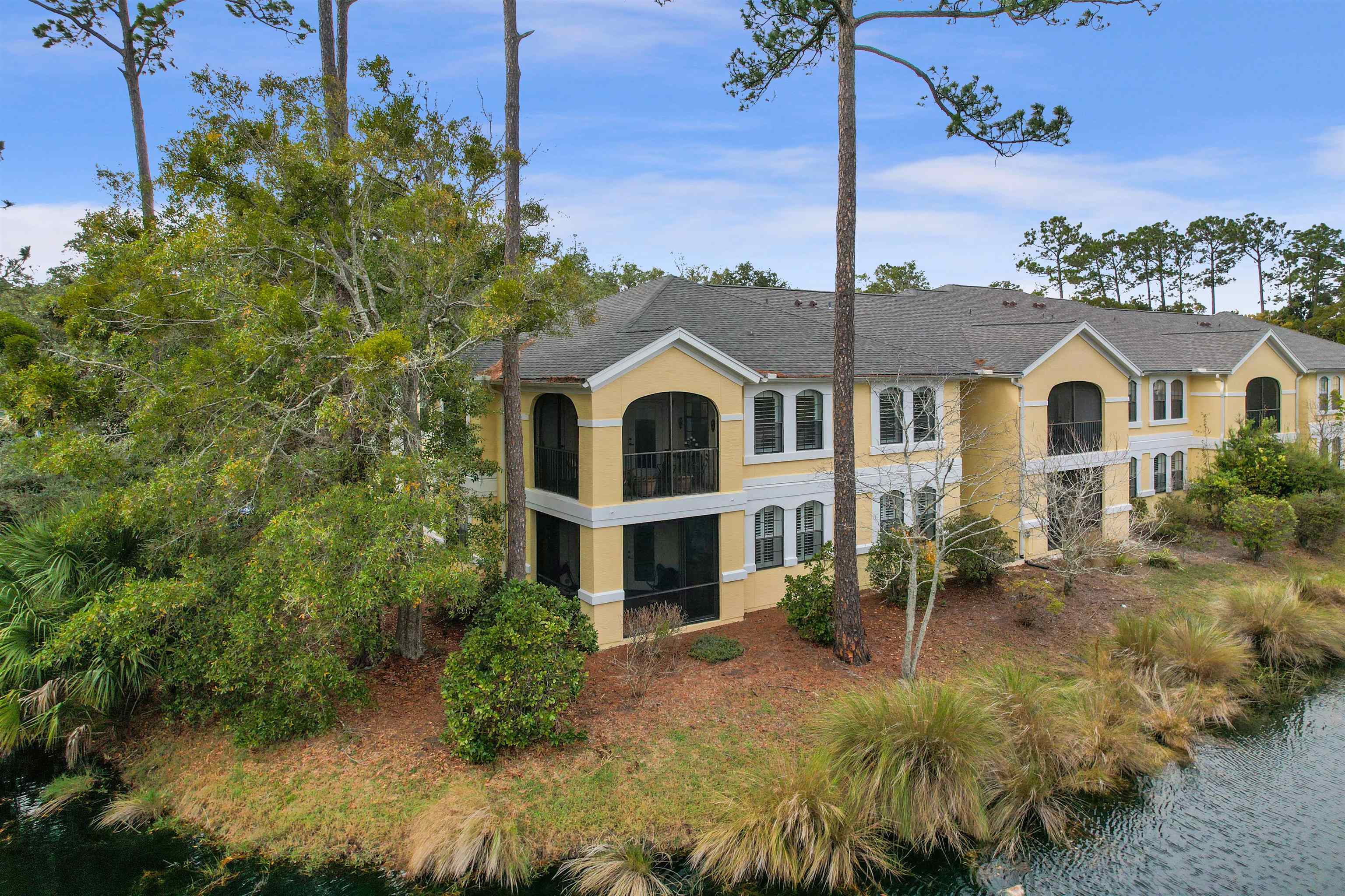 4629 Serena Circle St. Augustine, FL 32084 - Photo 36 of 47 a view of a big house with a small yard and large trees