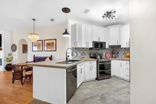 a kitchen with a stove sink and microwave