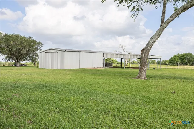 a view of a big yard with palm trees