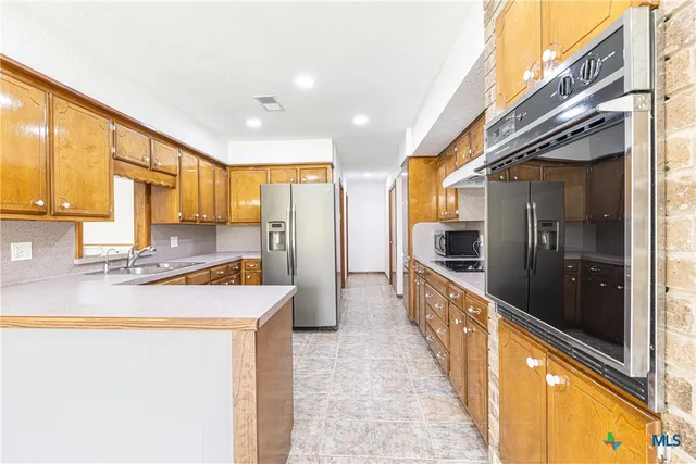 a view of a kitchen with a large window