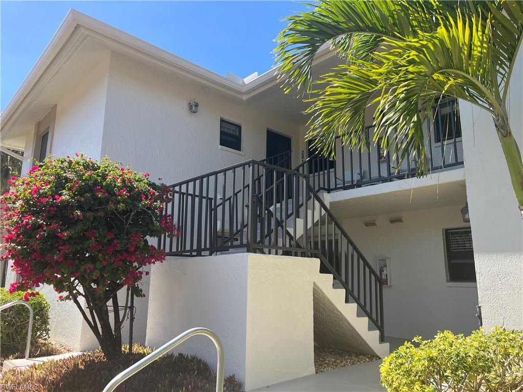 513 Lake Louise Circle, Unit 202 Naples, FL 34110 - Photo 1 of 15 a view of balcony and wooden floor