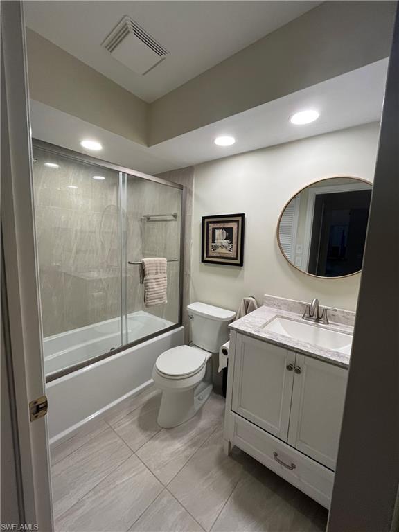513 Lake Louise Circle, Unit 202 Naples, FL 34110 - Photo 11 of 15 a bathroom with a toilet sink double vanity and mirror