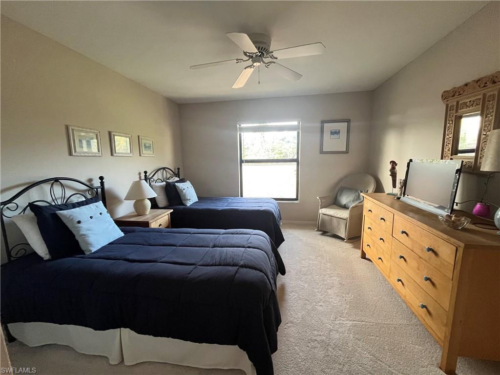 513 Lake Louise Circle, Unit 202 Naples, FL 34110 - Photo 12 of 15 a bedroom with bed and window