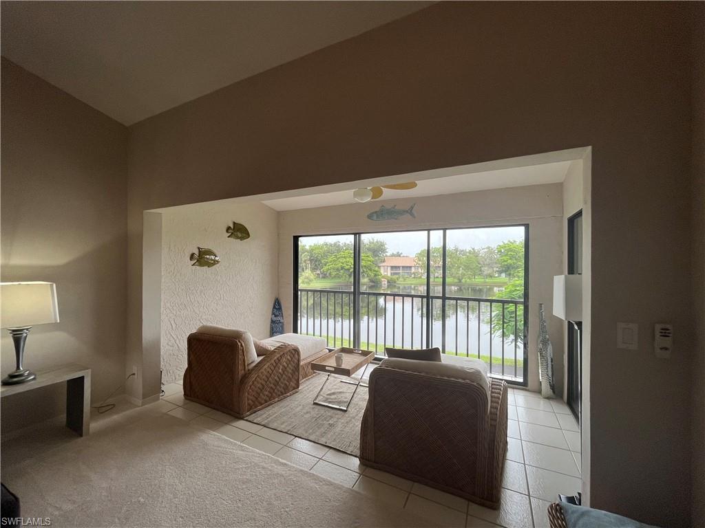 513 Lake Louise Circle, Unit 202 Naples, FL 34110 - Photo 14 of 29 a balcony with outdoor seating