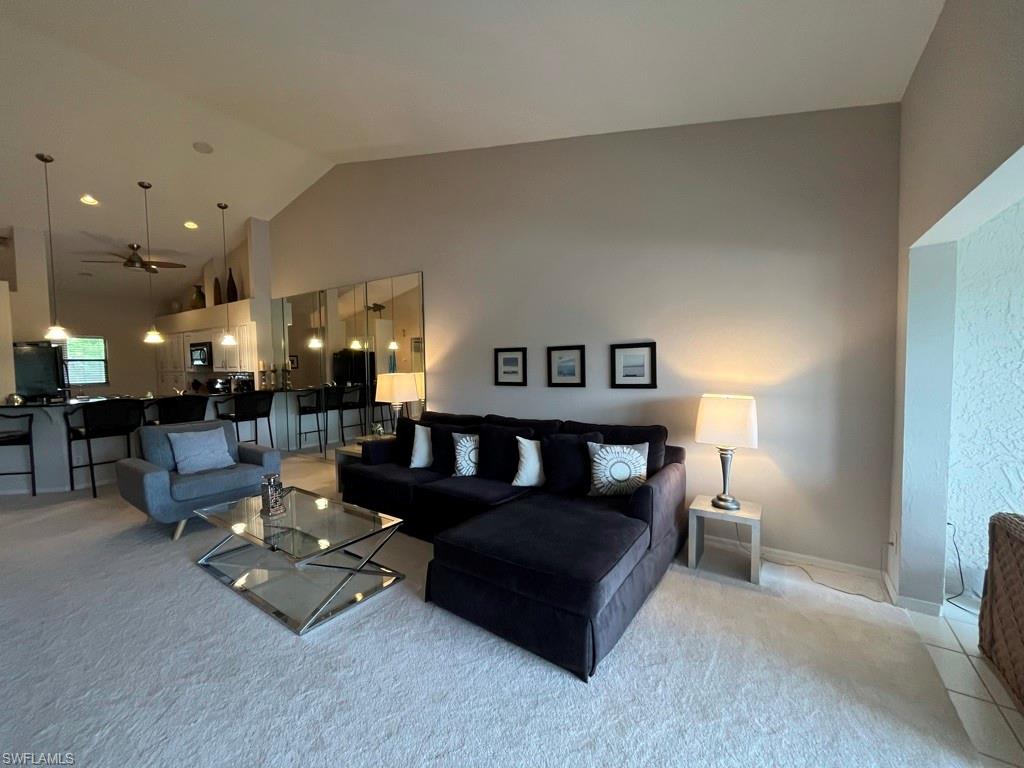 513 Lake Louise Circle, Unit 202 Naples, FL 34110 - Photo 6 of 15 a living room with furniture and a table