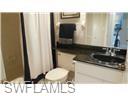 513 Lake Louise Circle, Unit 202 Naples, FL 34110 - Photo 9 of 29 a bathroom with a sink a toilet and a mirror