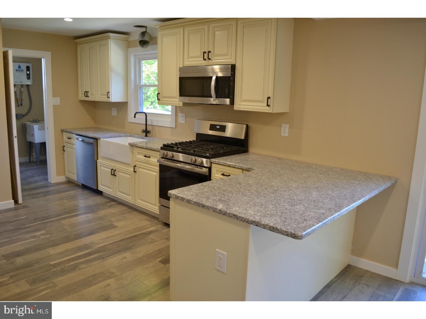 95 Duffield Street Willow Grove, PA 19090 - Photo 9 of 20 a kitchen with stainless steel appliances granite countertop a stove a sink and a microwave