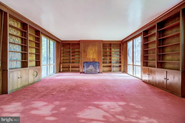 an empty room with windows and closet