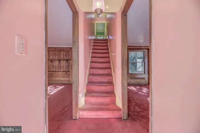 a kitchen with a refrigerator a stove and wooden floor