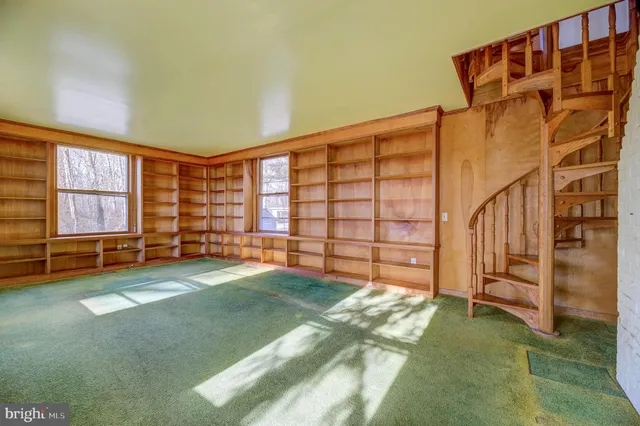 a view of an empty room with stairs and ventilation