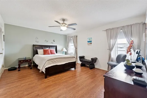 a bedroom with a bed gym equipment and a window