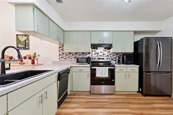 a kitchen with a refrigerator and a sink