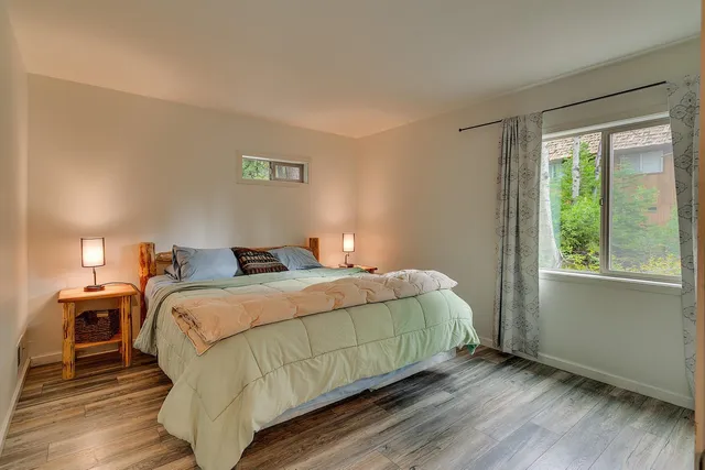 a bedroom with a bed and a ceiling fan