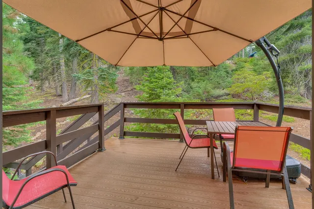 a backyard of a house with barbeque oven table and chairs
