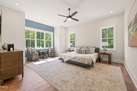 a spacious bedroom with a bed and a couch