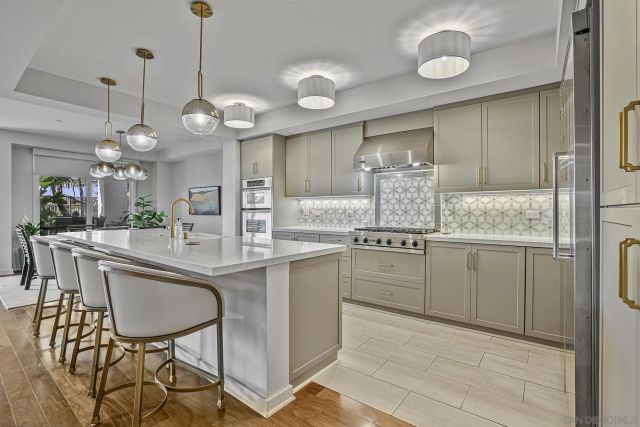 a kitchen with cabinets a sink and appliances