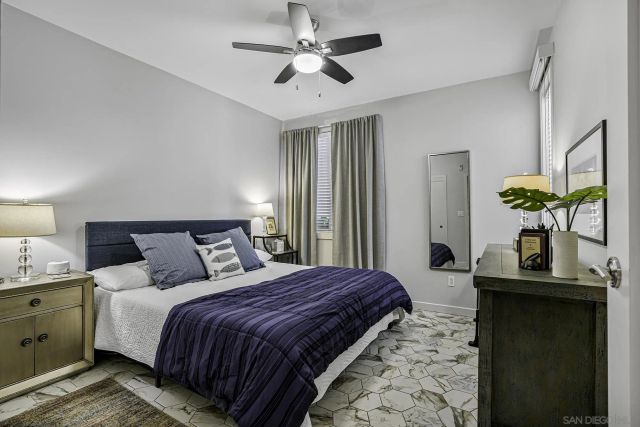 a bedroom with bed and a chandelier