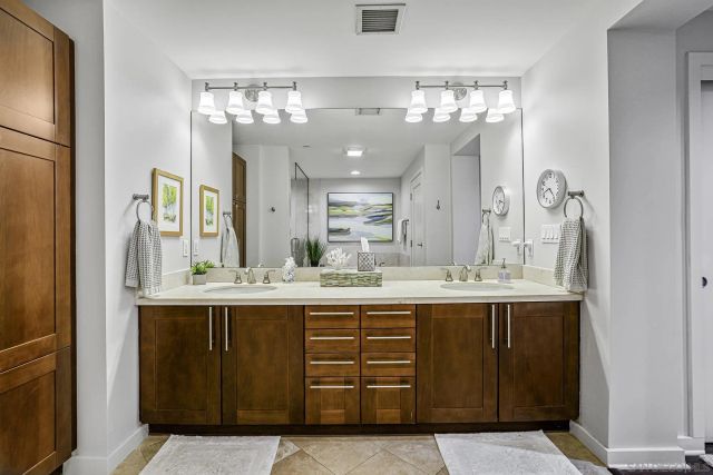 a view of a double sink and a large mirror in a room