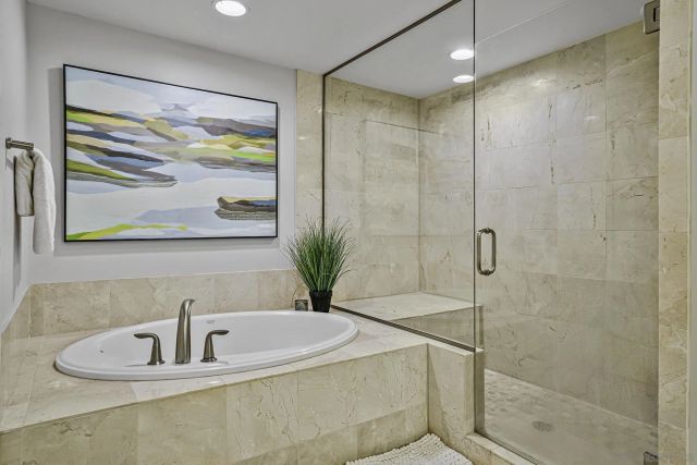 a bathroom with a bathtub and a shower
