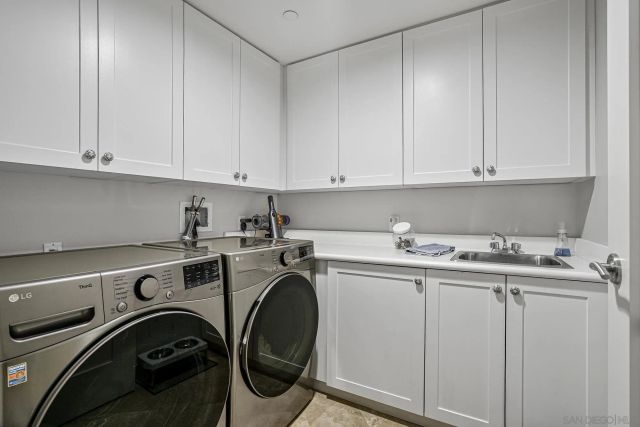 a utility room with sink dryer and washer