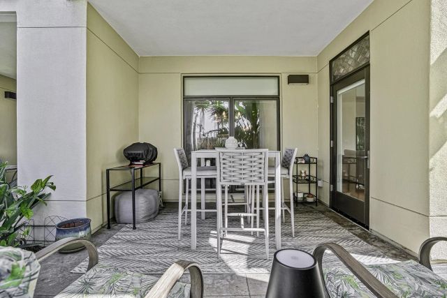 a dining room with furniture a potted plant and a rug