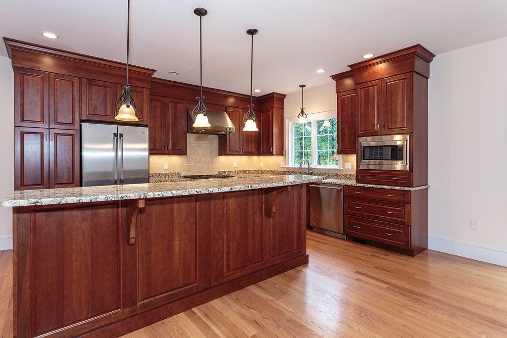 18 Shade Street Lexington, MA 02421 - Photo 11 of 23 a kitchen with kitchen island granite countertop wooden cabinets and wooden floor