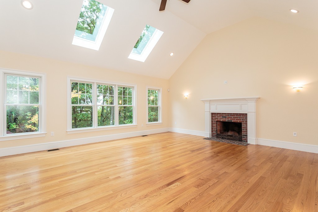 18 Shade Street Lexington, MA 02421 - Photo 13 of 23 a view of an empty room with wooden floor and a window