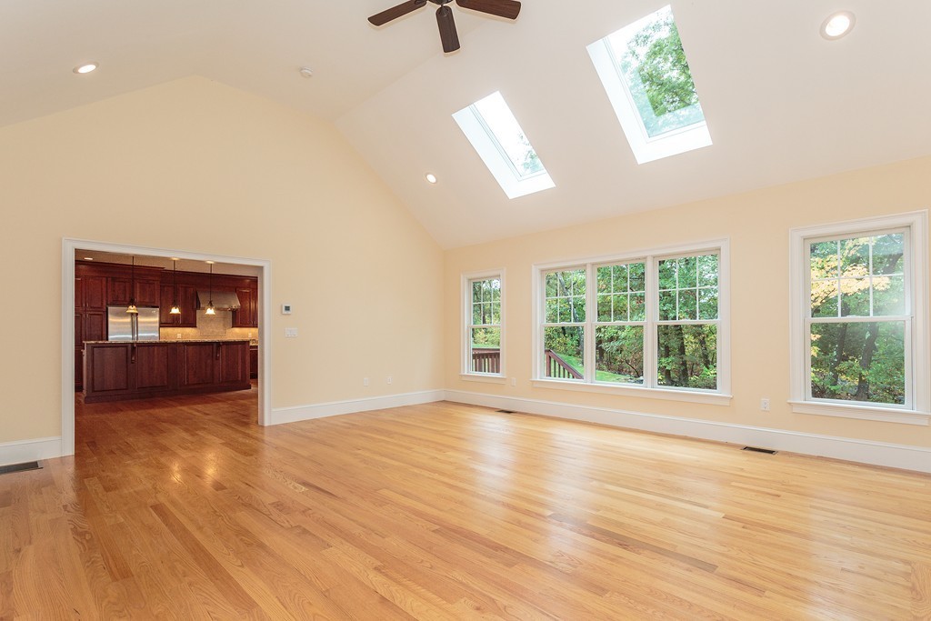 18 Shade Street Lexington, MA 02421 - Photo 14 of 23 a view of an empty room with a window and wooden floor