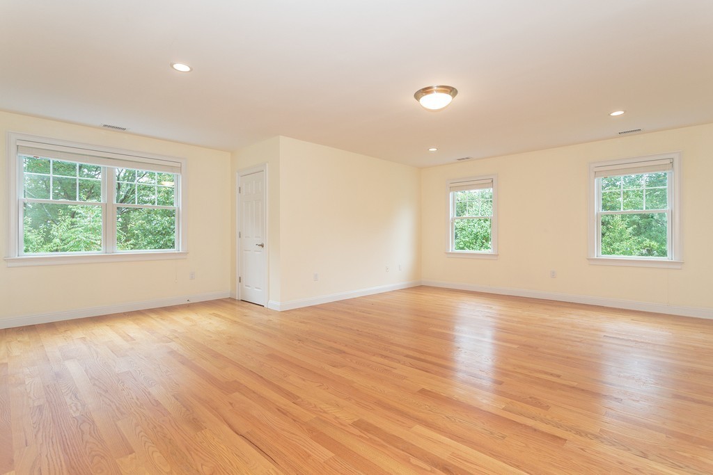 18 Shade Street Lexington, MA 02421 - Photo 15 of 23 an empty room with wooden floor and windows
