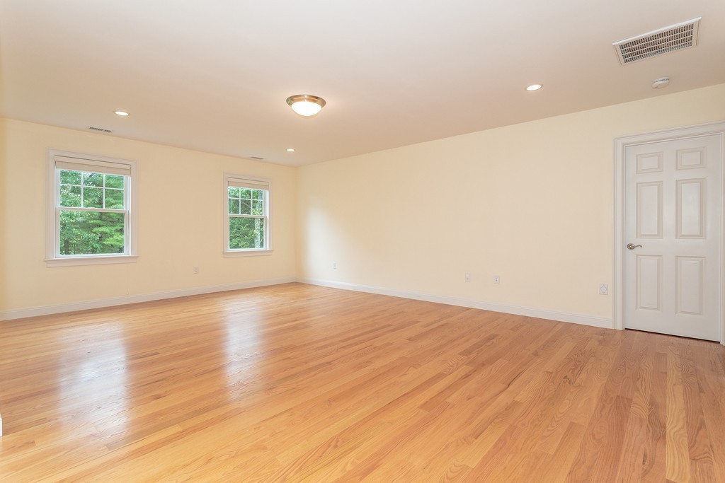 18 Shade Street Lexington, MA 02421 - Photo 16 of 23 an empty room with wooden floor and windows