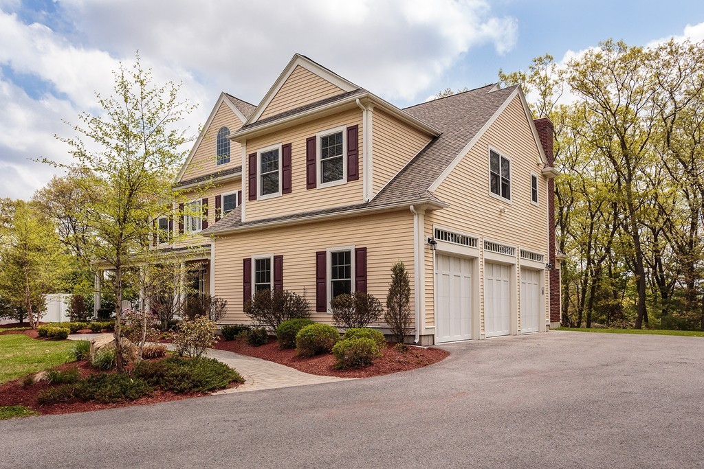 18 Shade Street Lexington, MA 02421 - Photo 2 of 23 a view of a white house next to a road and yard