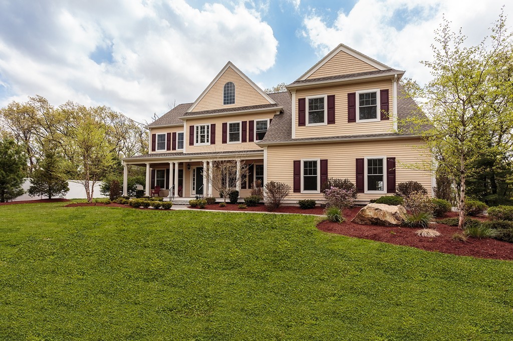 18 Shade Street Lexington, MA 02421 - Photo 22 of 23 a front view of a house with a garden