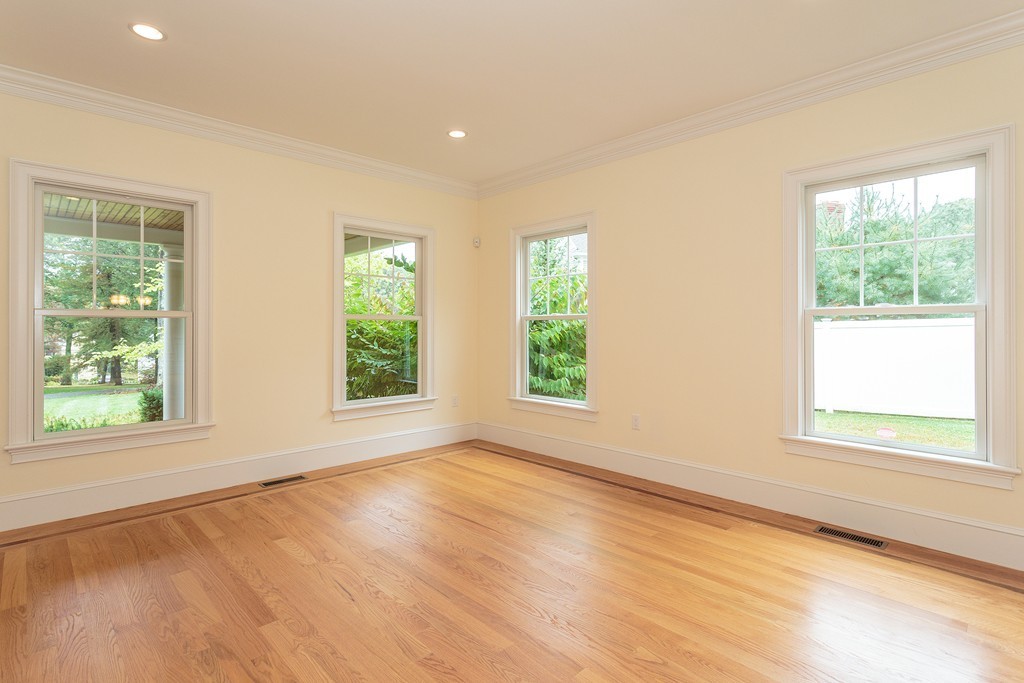 18 Shade Street Lexington, MA 02421 - Photo 5 of 23 an empty room with wooden floor and windows