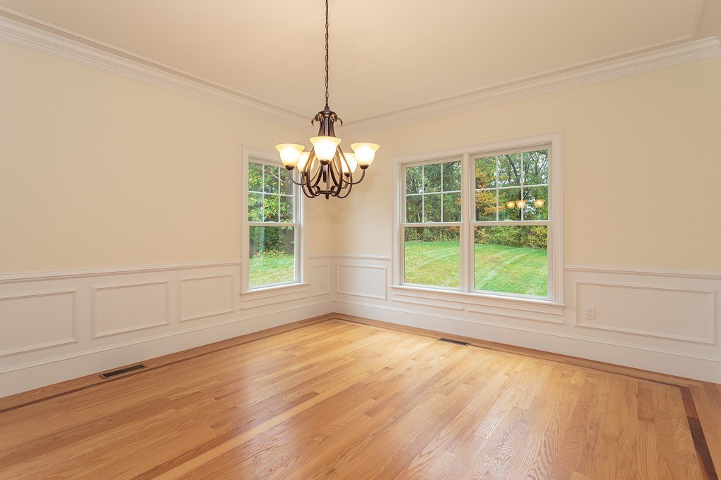 18 Shade Street Lexington, MA 02421 - Photo 6 of 23 a view of an empty room with wooden floor and a window