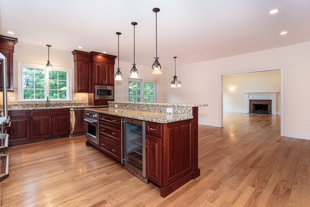 18 Shade Street Lexington, MA 02421 - Photo 8 of 23 a kitchen with stainless steel appliances granite countertop a stove a sink and a wooden floors