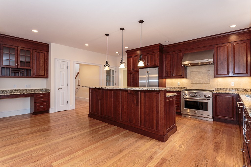 18 Shade Street Lexington, MA 02421 - Photo 10 of 23 a kitchen with stainless steel appliances granite countertop a stove a sink and a wooden floors