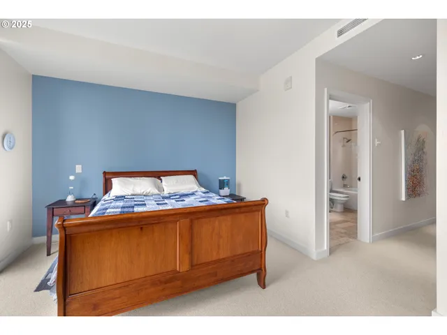 a room with a bed and mirror