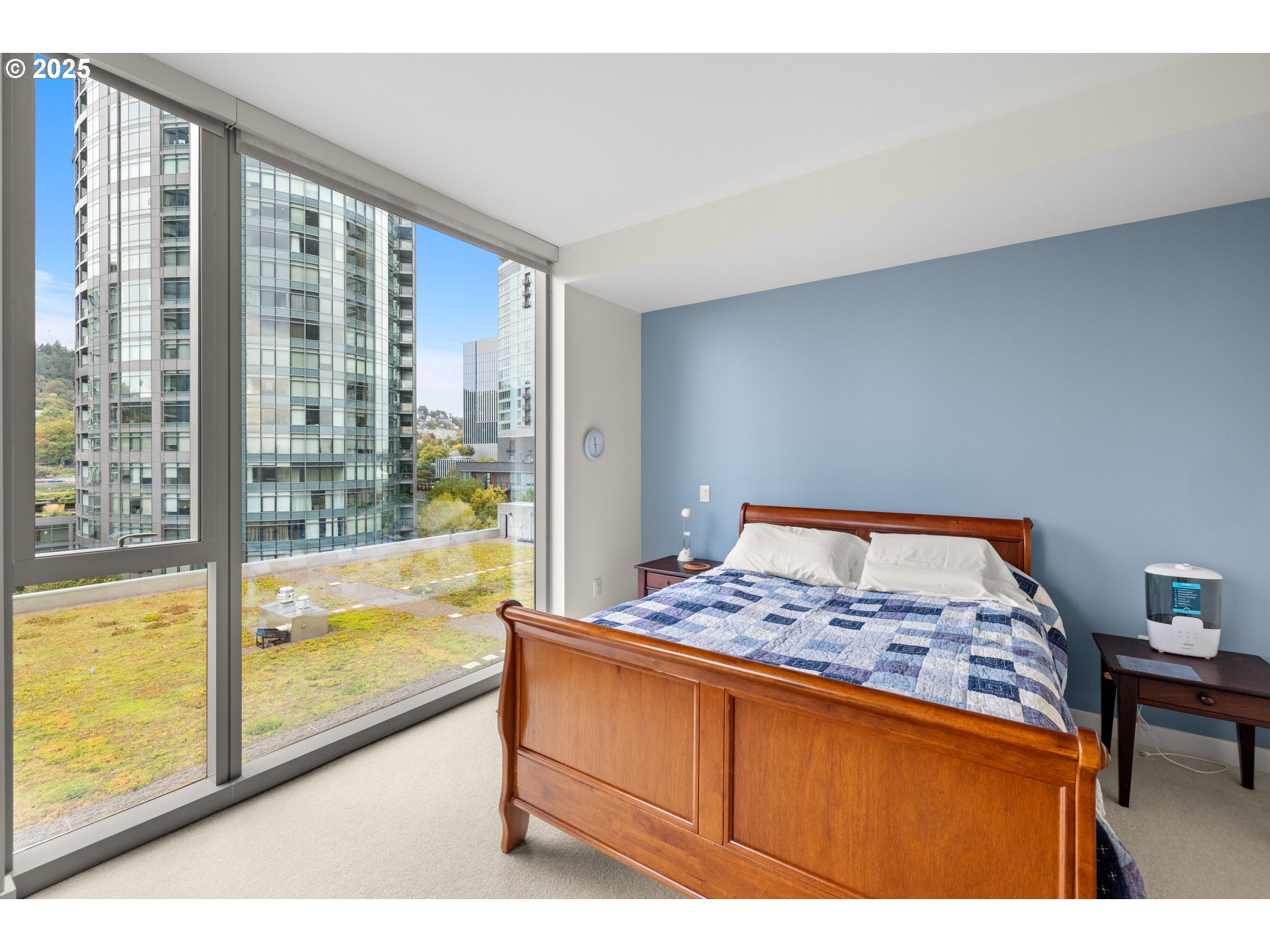 841 Southwest Gaines Street, Unit 714 Portland, OR 97239 - Photo 18 of 48 a bedroom with a bed and a large window