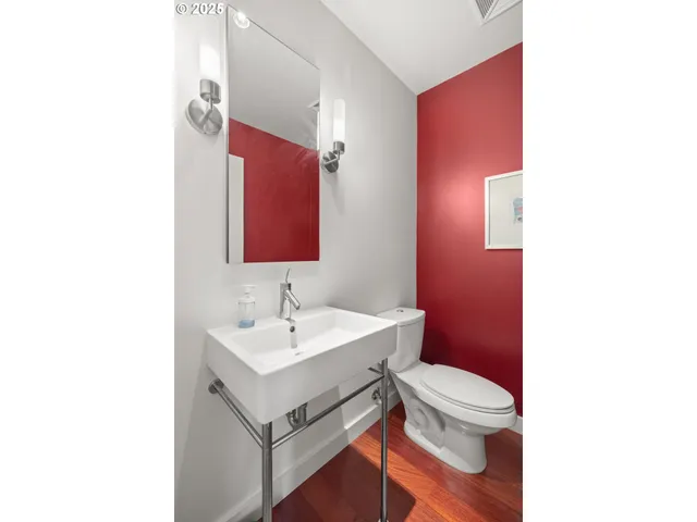 a bathroom with a sink toilet vanity and mirror
