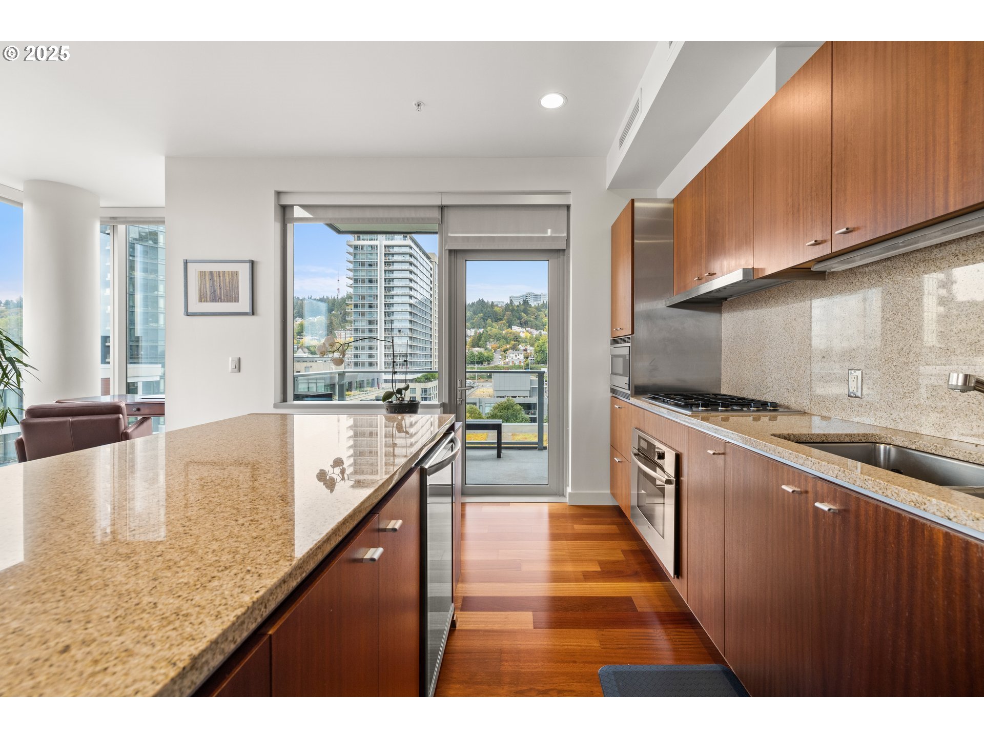 841 Southwest Gaines Street, Unit 714 Portland, OR 97239 - Photo 29 of 48 a large kitchen with kitchen island a large counter top and stainless steel appliances