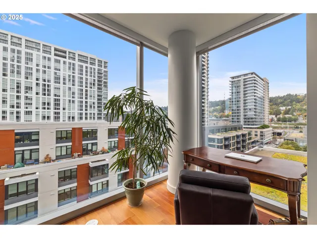 a living room with furniture and a floor to ceiling window
