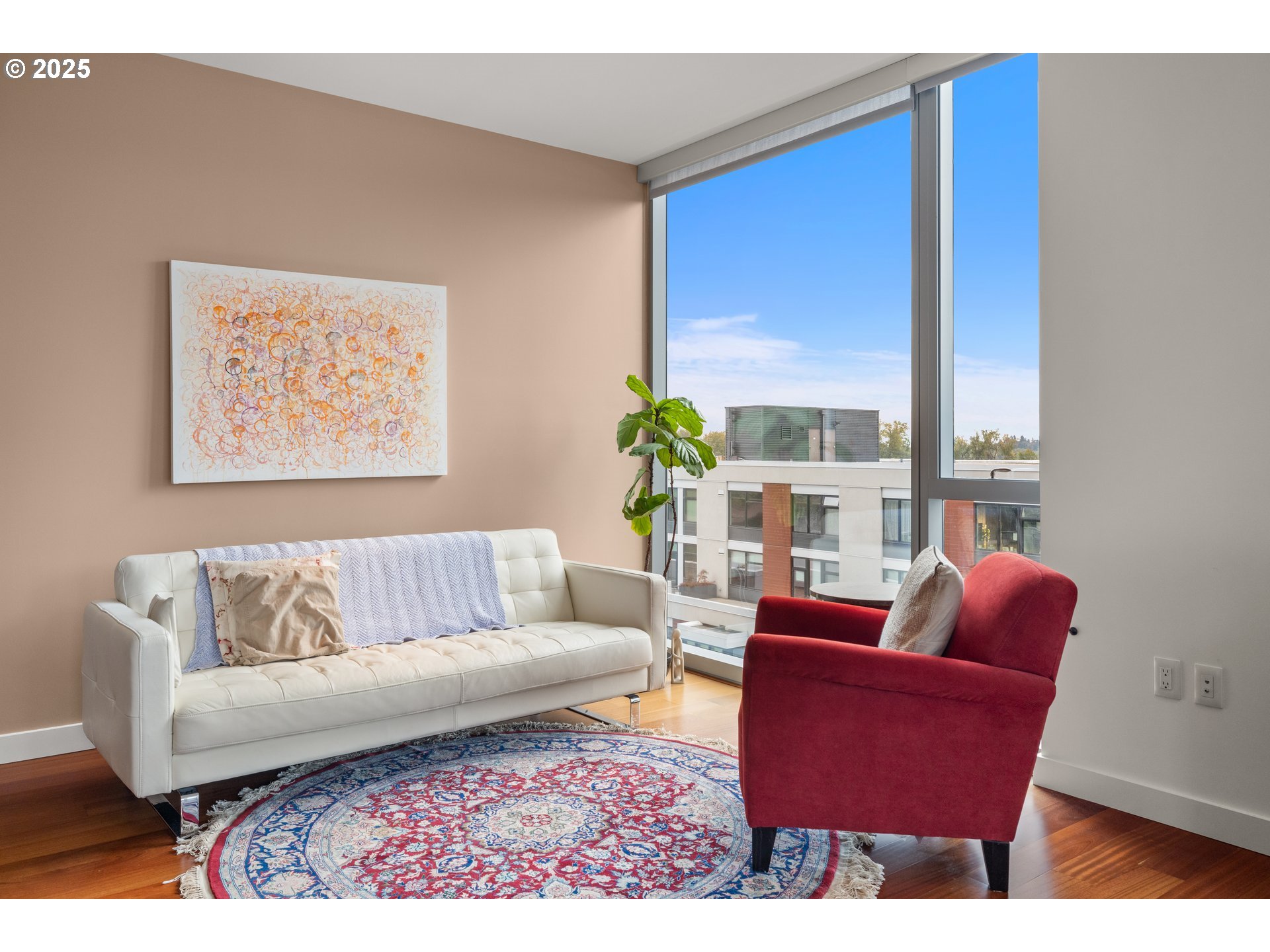 841 Southwest Gaines Street, Unit 714 Portland, OR 97239 - Photo 35 of 48 a living room with furniture a large window and a potted plant