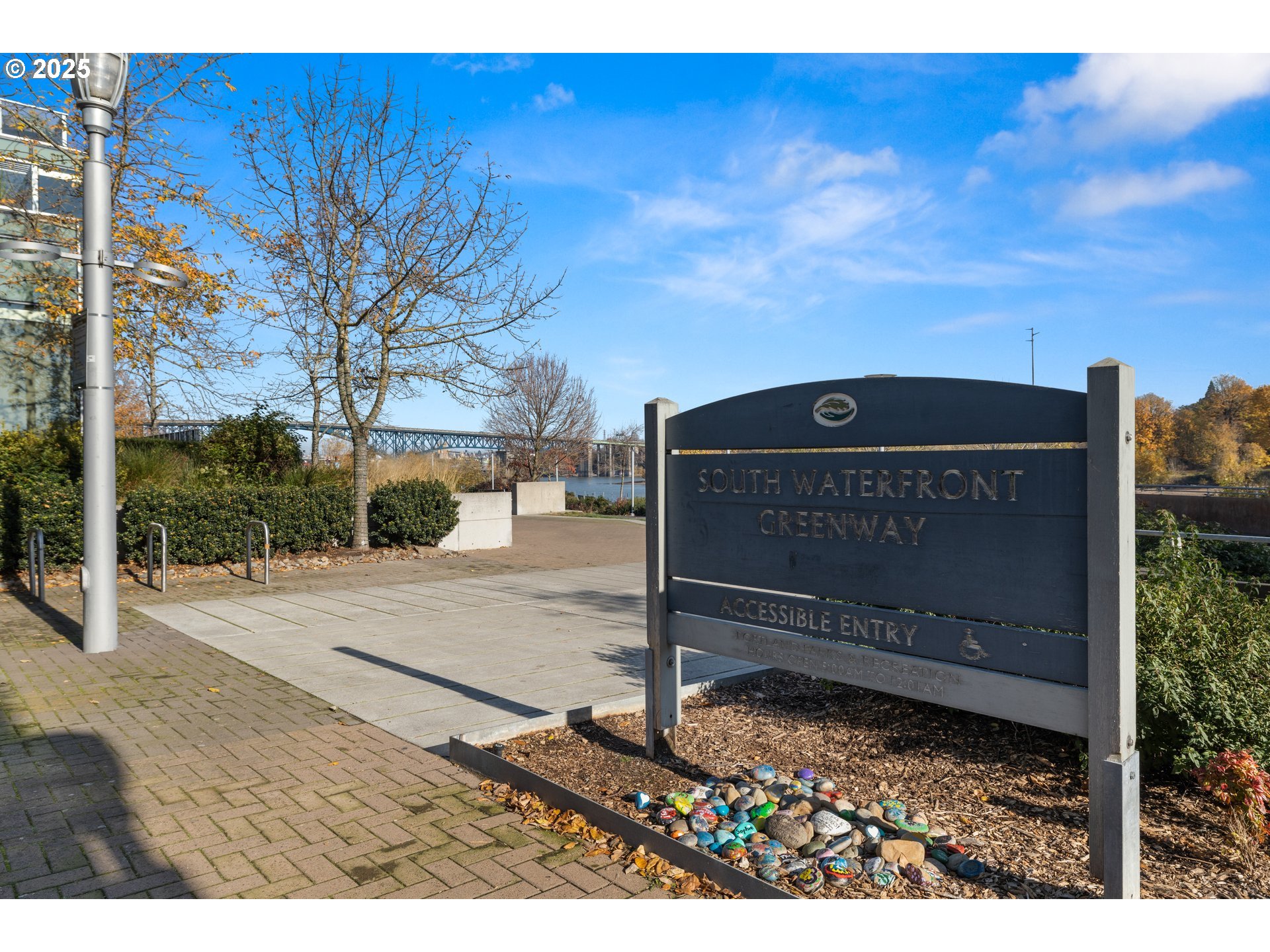 841 Southwest Gaines Street, Unit 714 Portland, OR 97239 - Photo 38 of 48 a view of a wooden fence and a sign board