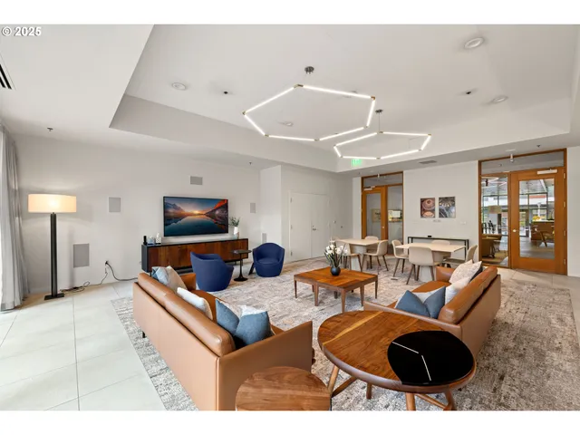 a living room with furniture a rug and white walls